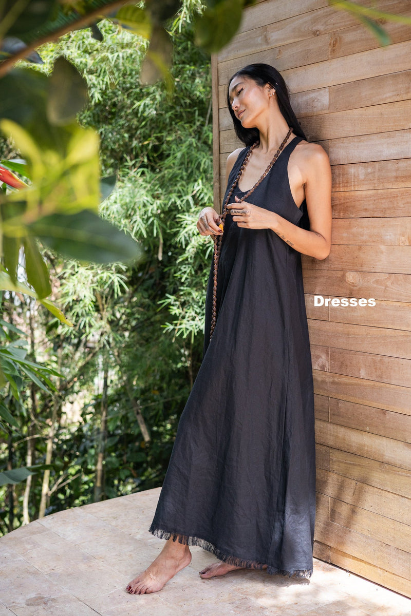 A-Woman-standing-in-front-of-an-ornamented-door-wearing-Shivani-dress-showing-her-back-design